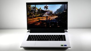 Dell G16 (7630) open on a white table with Far Cry 6 on screen.