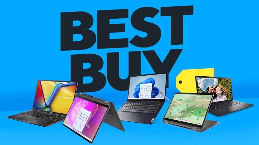 Laptops in front of a Best Buy logo on a blue background